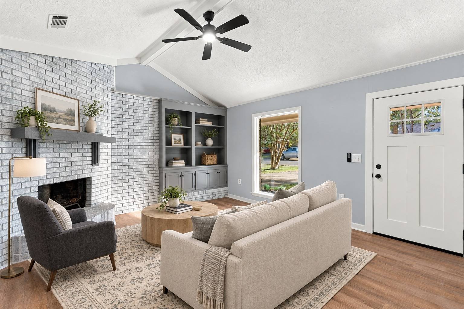 Living room with brick fireplace and built-in shelving at 2381 Deer Oak Place