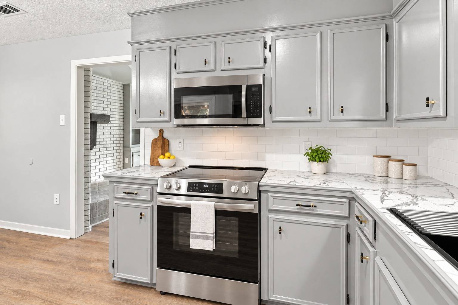 Renovated kitchen with stainless steel range and microwave at 2381 Deer Oak Place