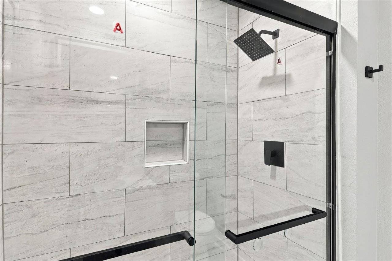 Tiled walk-in shower with glass door at 2381 Deer Oak Place