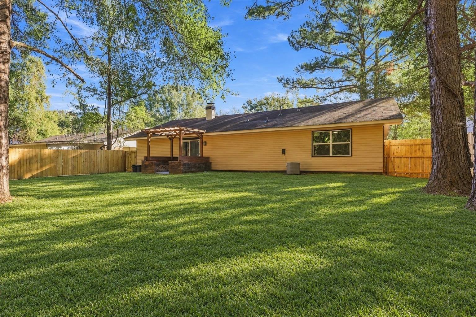 Backyard with mature trees at 2381 Deer Oak Place