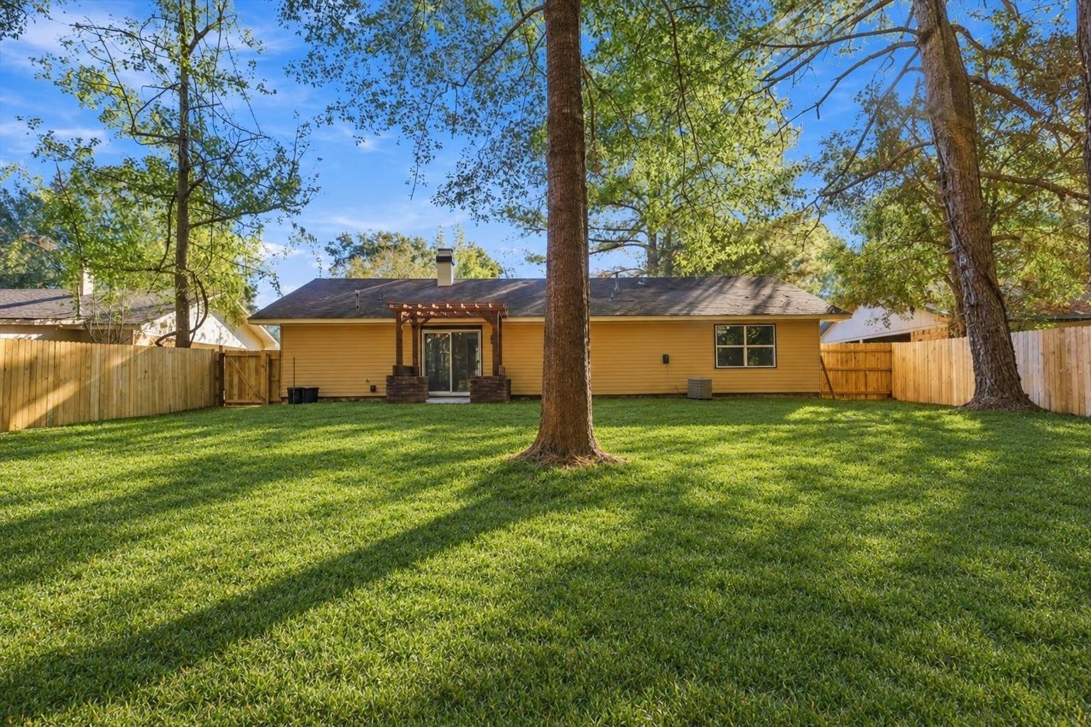 Backyard with new privacy fence at 2381 Deer Oak Place