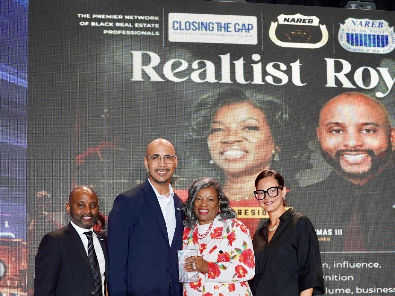 Dr. Zakk Varughese accepting the NAREB Top 100 award on stage at the 2026 Realtist Royale in Las Vegas