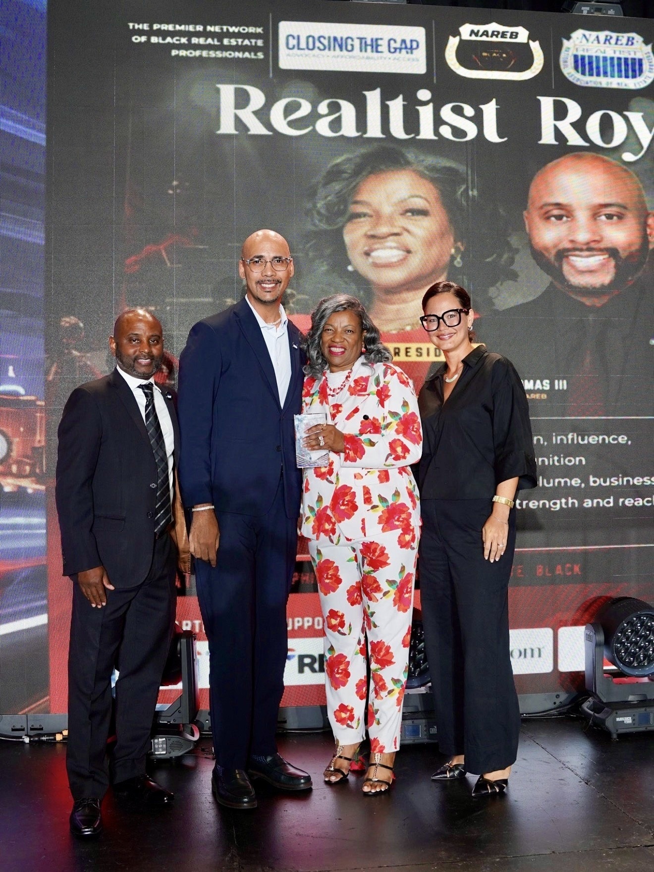 Dr. Zakk Varughese accepting the NAREB Top 100 award on stage at the 2026 Realtist Royale in Las Vegas